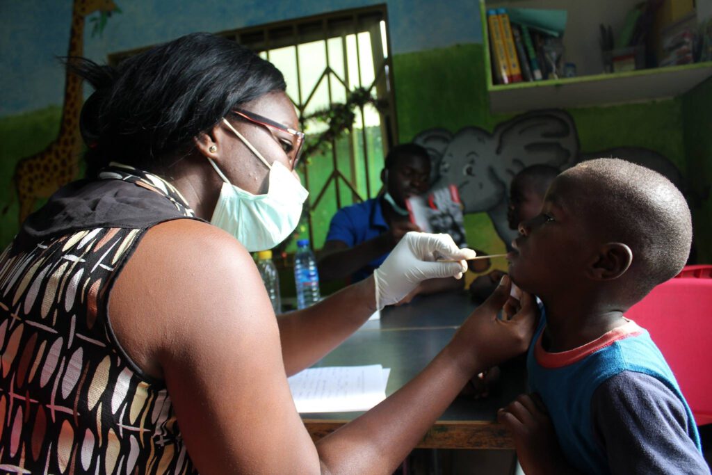 Dentist volunteer at work with child
